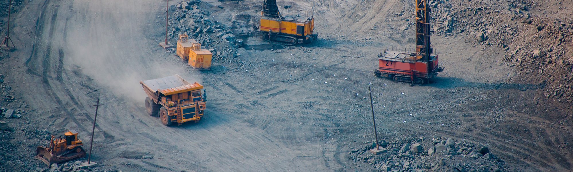 Open-pit mining equipment: haul truck, drill rigs and bulldozer